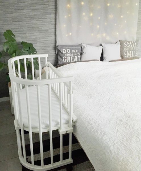 babybay bedside co-sleeper set up next to a bed | babybay bedside bassinets