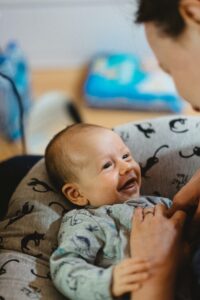 A parent and smiling child after finding solutions to deal with sleep deprivation with a baby | babybay bedside co sleepers