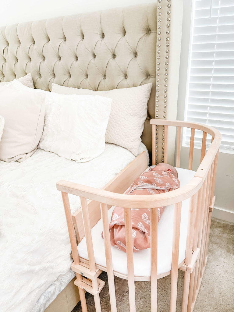 Baby practicing safe co sleeping in a bedside co sleeper | babybay bedside sleeper
