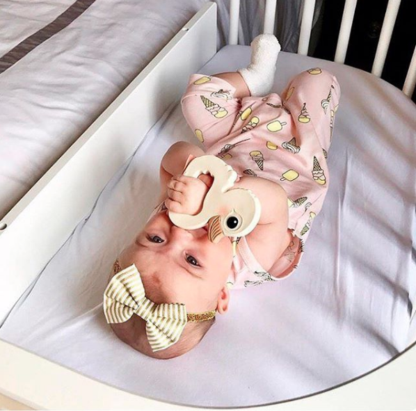 A baby lying in her bedside co-sleeper | babybay Bedside Bassinets
