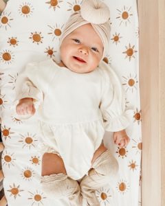 Co-sleeping baby smiling into camera | babybay bedside bassinets