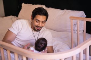 A father and baby enjoying all the benefits of co-sleeping | bbybay bedside co-sleepers 