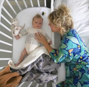 Mother nurturing baby to ease separation anxiety in babies | babybay bedside sleepers