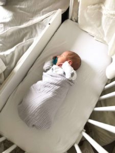 A baby knowing how to co sleep safely with bedside sleeper | babybay bedside co sleepers
