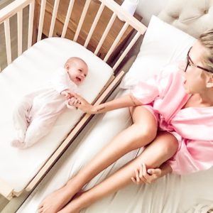Mother and baby laughing together as a co-sleeping family | babybay bedside co-sleepers