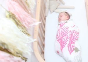 Baby sleeping while family thinks about how to stop co-sleeping | babybay bedside co-sleepers