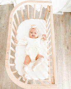 A baby in a mobile bedside bassinet | babybay bedside bassinets