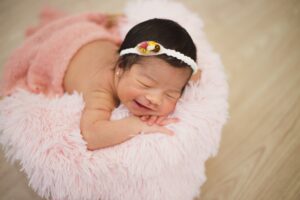 Baby lying comfortably on a comfy pillow | babybay bedside bassinets 