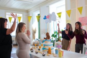 Guests playing baby shower games at a party | babybay bedside sleepers