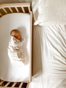 A baby in a co sleeping bed for newborn | babybay bedside sleeper