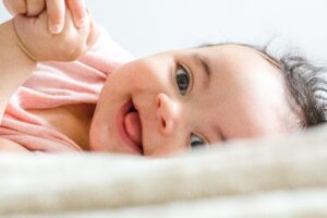 Baby with huge smile | babybay bedside co-sleepers